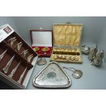 A pair of silver salts, cased, a silver salt spoon, six silver golf spoons, a cruet set and tray and