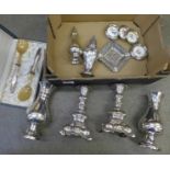 A collection of silver plate items including candlesticks, sugar sifters, a set of wine coasters,