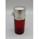 A Victorian cranberry glass perfume bottle with hallmarked silver top and collar and inner glass