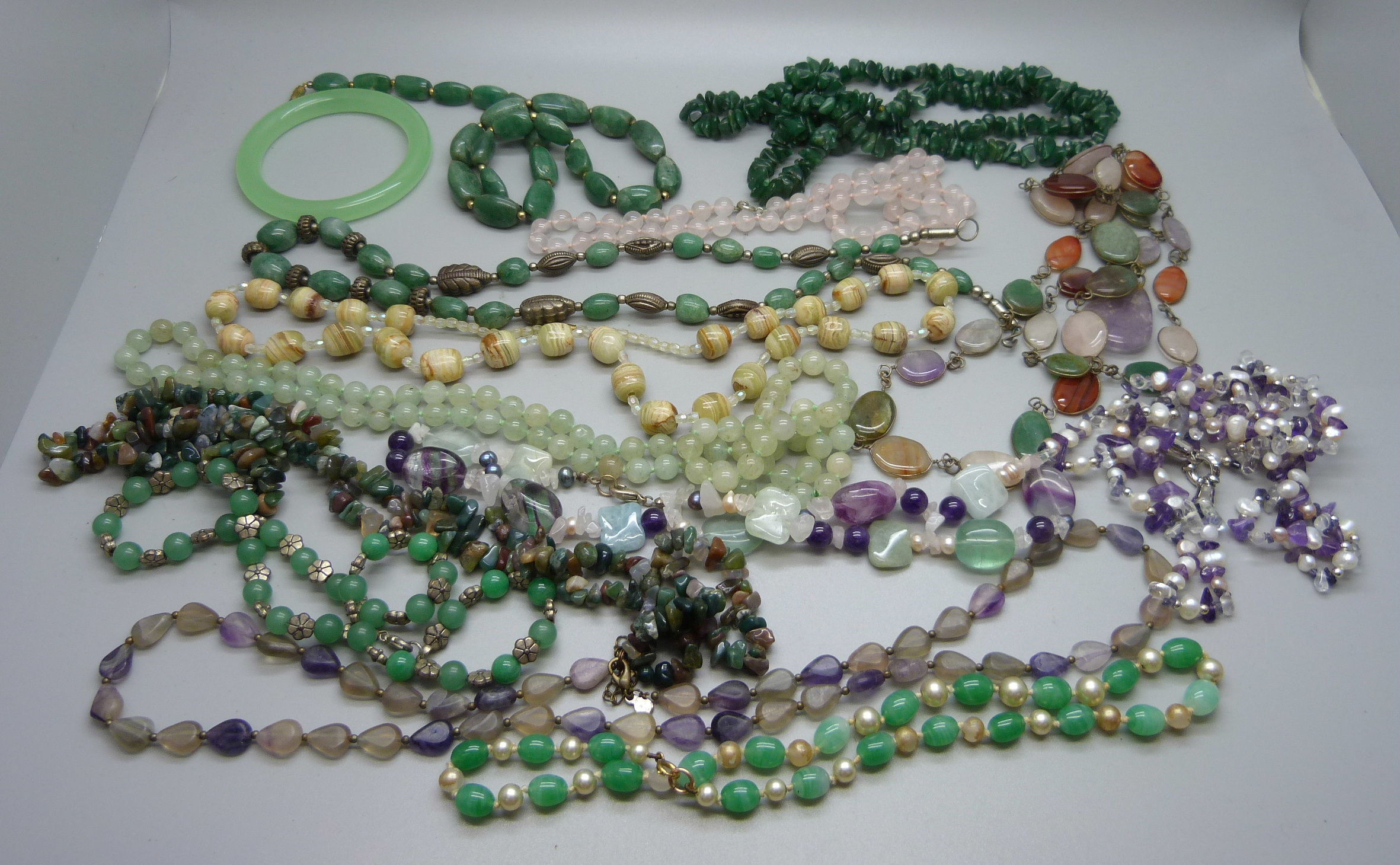 A collection of bead necklaces including pearl, amethyst and jadeite