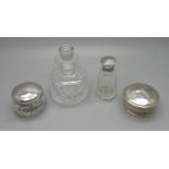 A silver topped glass scent bottle with inner stopper, a silver topped glass jar, a cut glass bottle