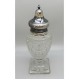 A silver topped cut glass sugar shaker