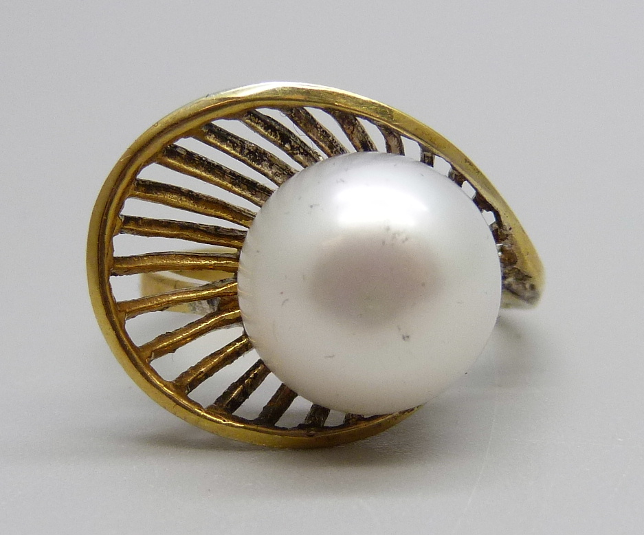 A silver gilt and pearl ring, S