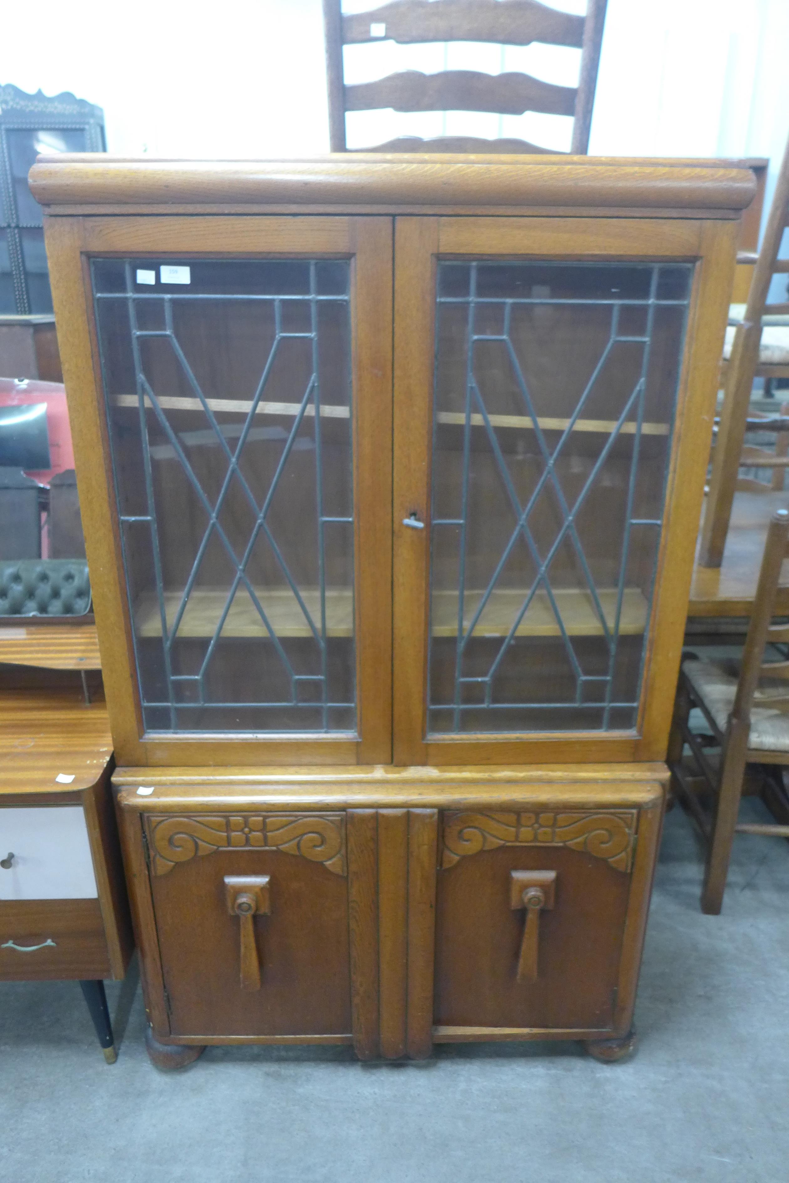 A carved oak display cabinet