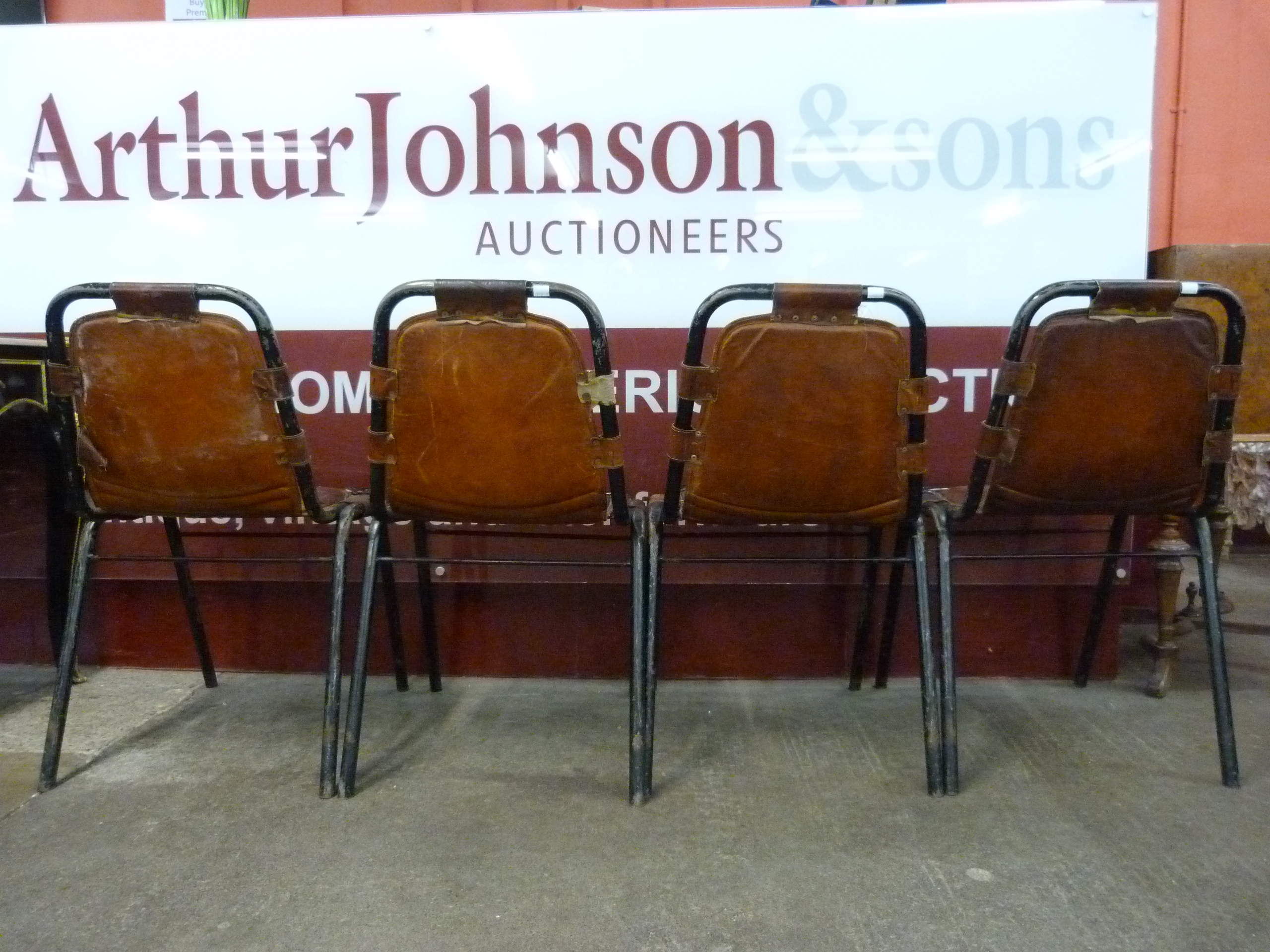 A set of four Les Arcs style black metal and brown leather chairs, attributed to Charlotte Perriand - Image 4 of 4