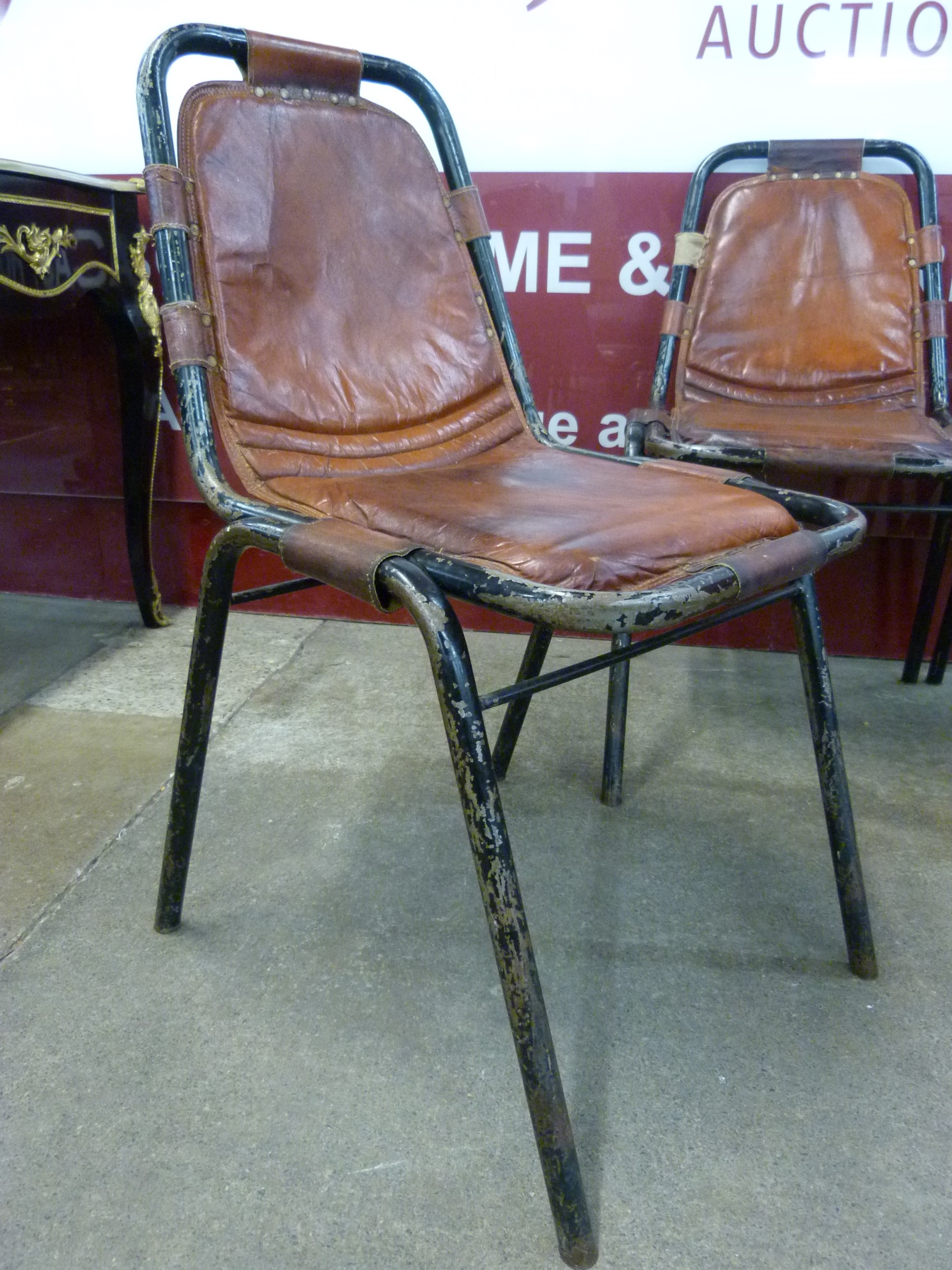 A set of four Les Arcs style black metal and brown leather chairs, attributed to Charlotte Perriand - Image 2 of 4