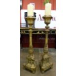 A pair of large Italian ecclesiastical brass candlesticks