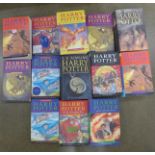 A collection of thirteen Harry Potter books including first editions