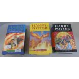 Three Harry Potter books, all first editions