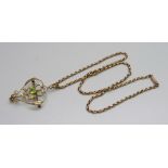 A 15ct gold Art Nouveau peridot and half pearl pendant and a 9ct gold chain, (2.7g and 5.7g),