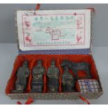 A boxed set of terracotta oriental figures