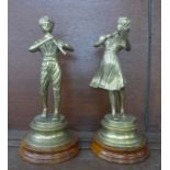 A pair of brass figures of musicians on wooden bases, 27.5cm