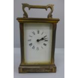 A gilt brass and four glass sided carriage clock with long service inscription plaque to the front