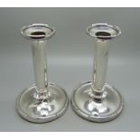 A pair of silver candlesticks, weighted bases, 633g gross weight, 13cm, a/f