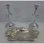 A pair of plated candlestick holders and embossed tray