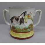 A Staffordshire Pottery frog mug; two handled jug decorated with dogs and with a figure of a frog on