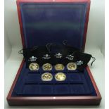 Six gold plated commemorative coins in a case