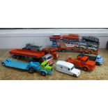 Die-cast model vehicles; a car transporter, flat bed lorry and a low-loader with a mix of Dinky