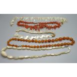 A coral necklace, three mother of pearl necklaces and an amber coloured bead necklace