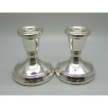 A pair of silver dwarf candlesticks, weighted bases, 203g gross weight