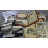 A collection of postcards and photographs including topographical war related scrap books, etc.,