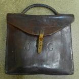 A leather document case, with initials