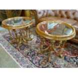 A pair of Regency style mahogany and glass topped circular occasional tables