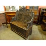 A Victorian Jacobean Revival carved oak hall seat