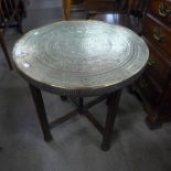 An Islamic brass topped folding table