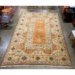 An eastern terracotta ground rug, 374 x 254cms