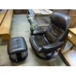 A black leather revolving lounge chair and stool