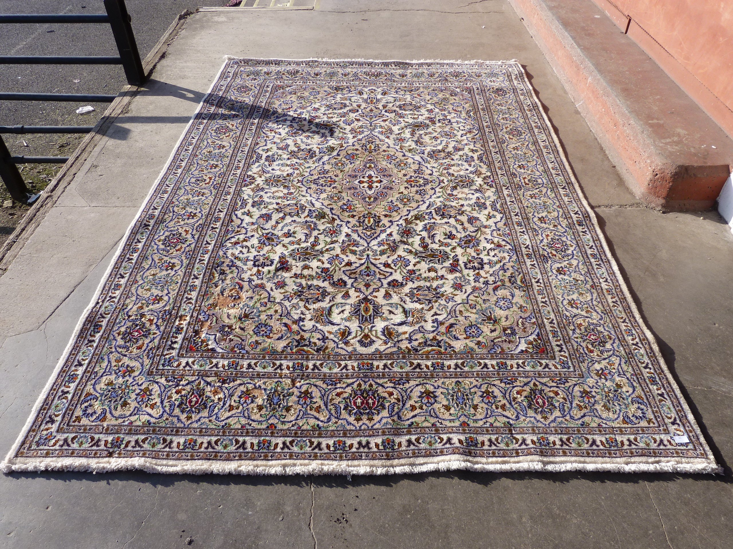 A Persian cream ground Kashan rug, 295 x 200cms, a/f