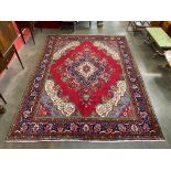 A Persian red ground rug, 398 x 289cms