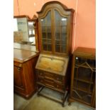 An early 20th Century oak dwarf sized oak barleytwist bureau bookcase