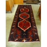 A Persian red ground Hamadan runner rug, 115 x 298cms