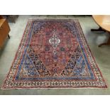 A Persian terracotta ground rug, 335 x 238cms