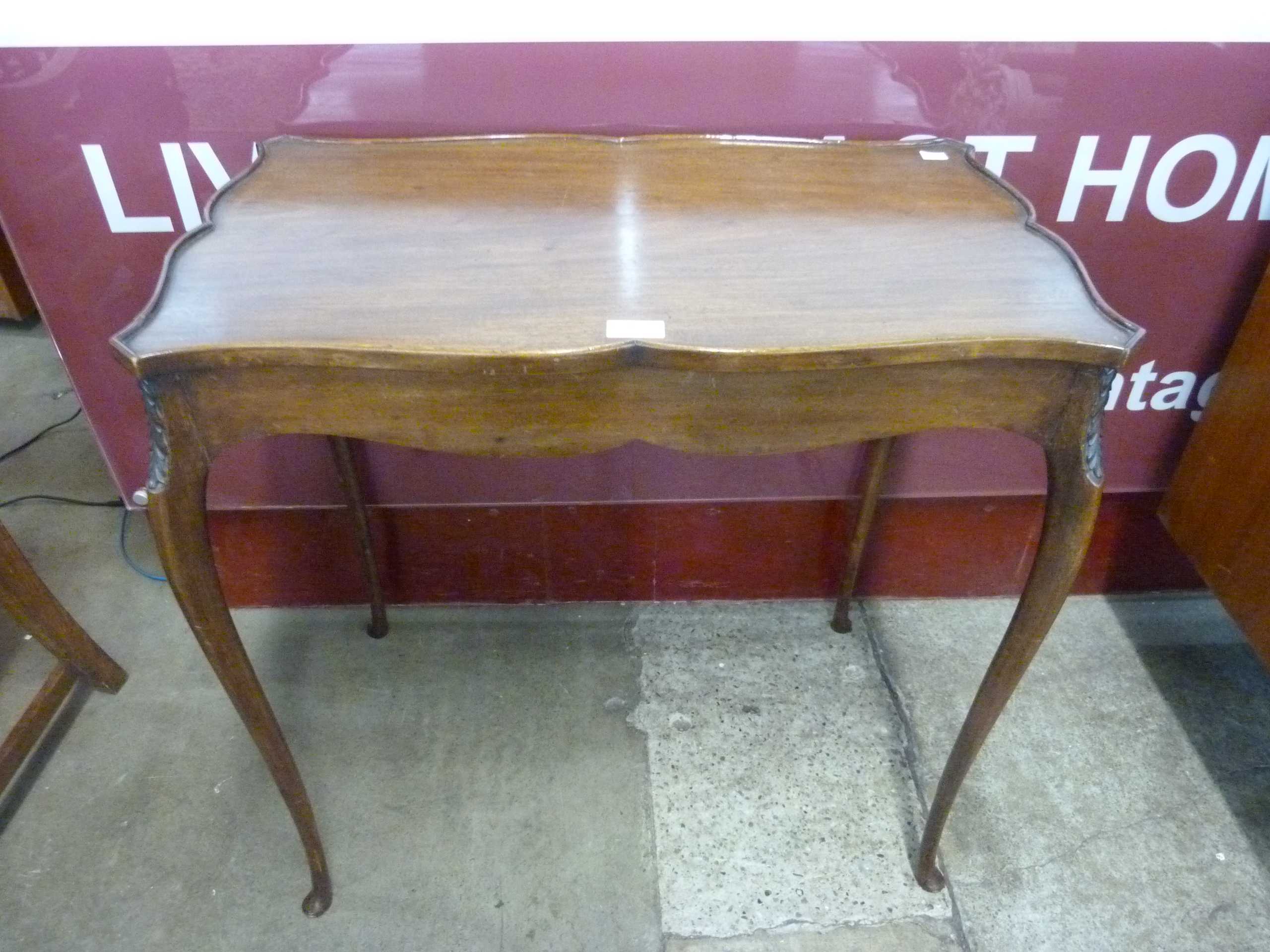 A Hepplewhite style mahogany serpentine silver table