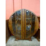 An Art Deco walnut circular two door display cabinet