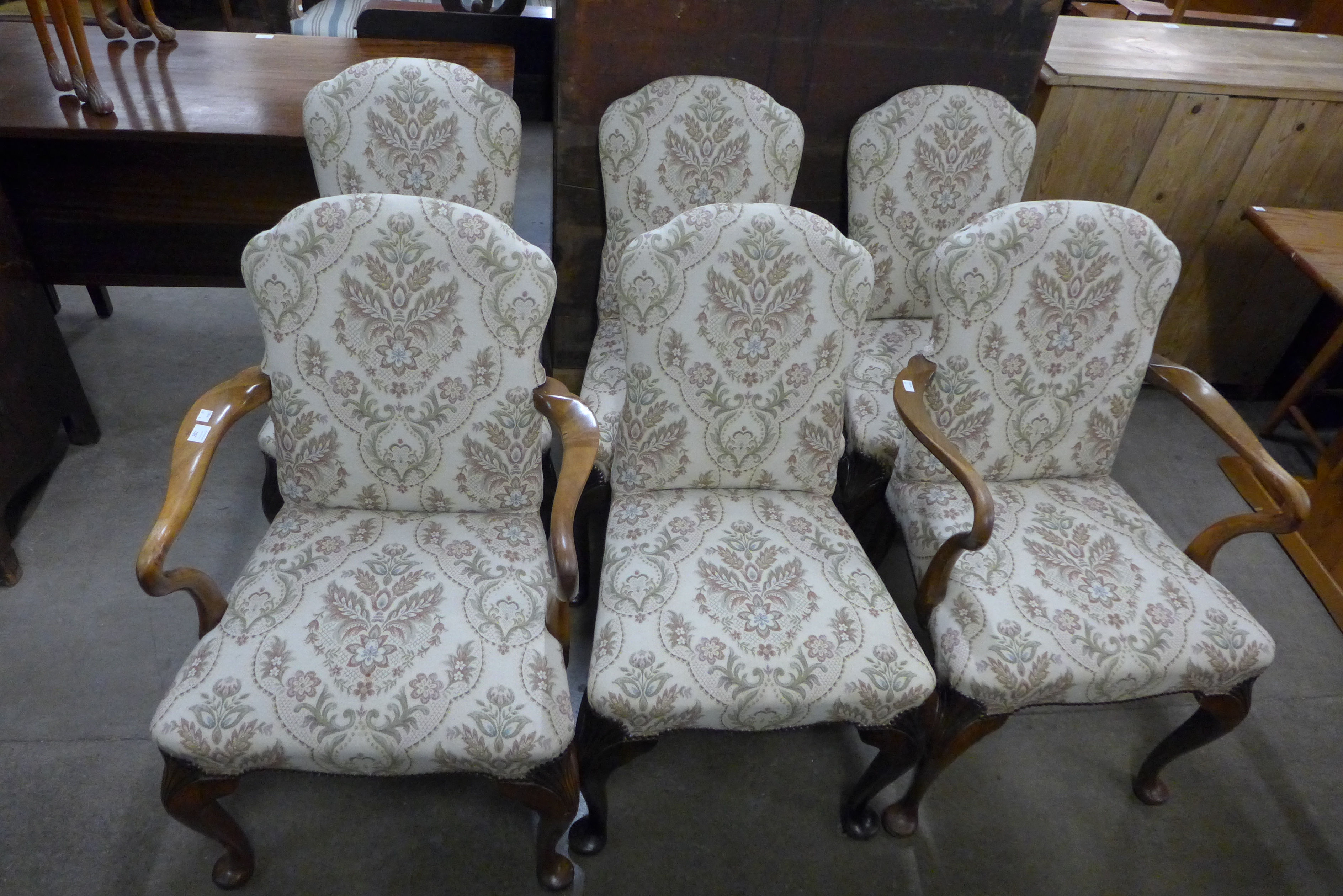 A set of six Queen Anne style walnut and fabric upholstered dining chairs