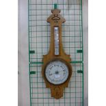 An Edward VII oak aneroid barometer