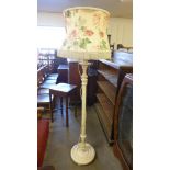 A cream painted standard lamp