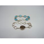 A silver and stone set bracelet, 18g, and a blue stone set bracelet