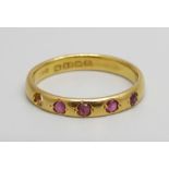 A 22ct gold ring, set with rubies, lacking one, 3.5g, O