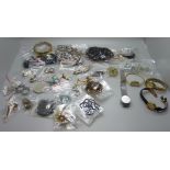 A collection of costume jewellery including brooches, bead necklaces, wristwatches, etc.