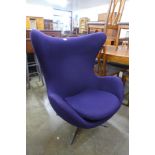 An Arne Jacobsen style chrome and purple fabric revolving lounge chair