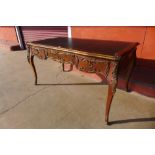 A French rosewood, gilt metal mounted and black leather topped three drawer bureau plat