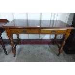 A late Victorian mahogany two drawer writing table