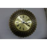 A brass circular wall clock