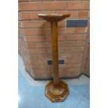 A Mouseman oak jardiniere or candle stand, 91cms h
