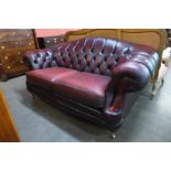A Thomas Lloyd burgundy leather Chesterfield settee